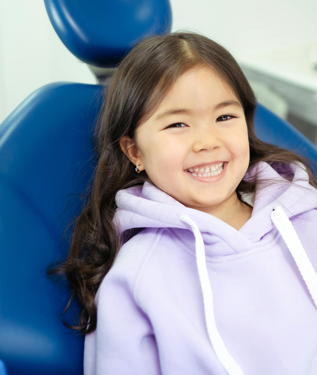 A Smiling child in a dentists chair