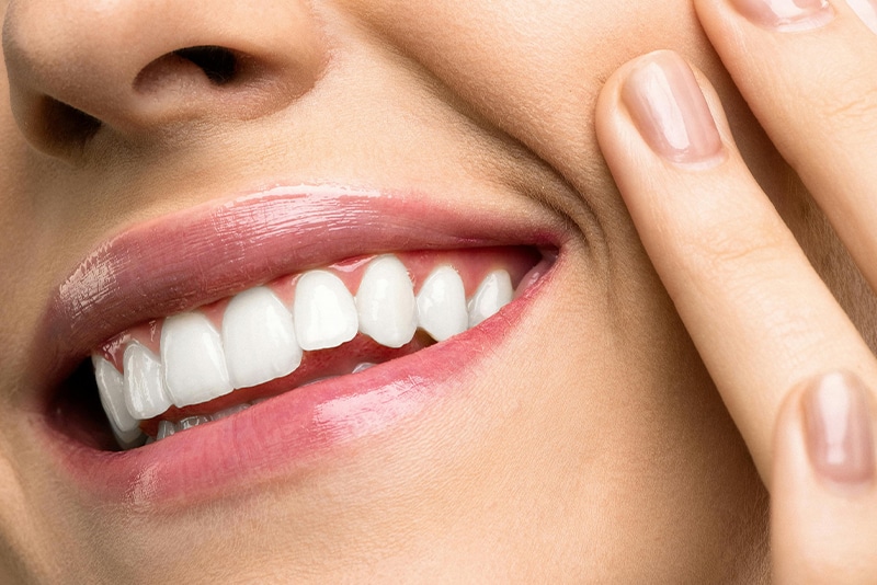 Woman with perfect crowns and bridges smiling