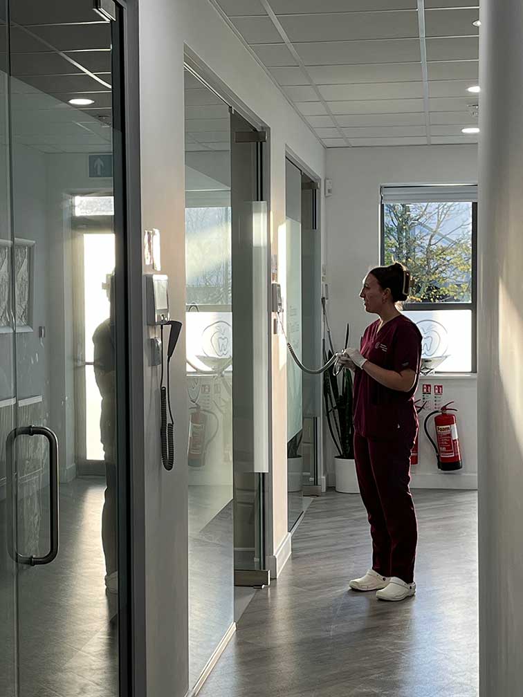 Online_Dental_Referrals_Dental_Nurse_in_Corridor Dental nurse stood in corridor at Eilertsen Dental Care